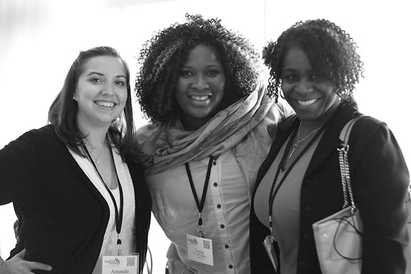 three women arm in arm smiling