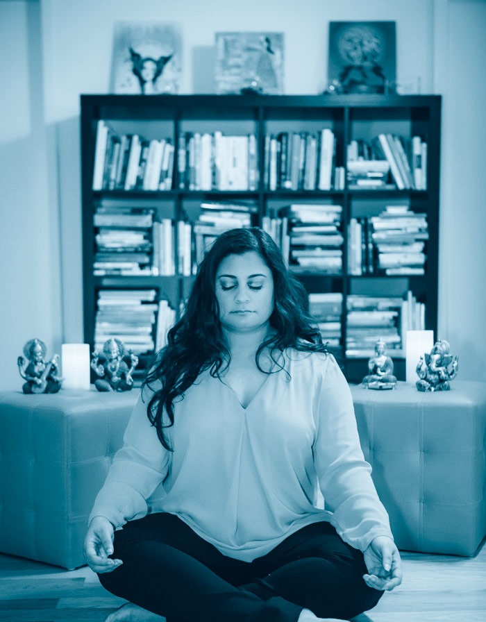 Monica meditating blue background