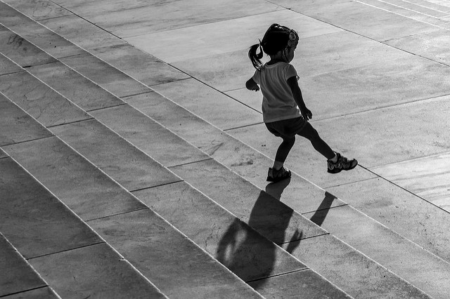 Little girl playing in puddles image