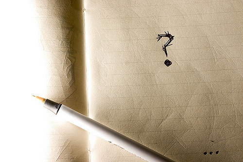 Question mark written on couch cushion in pen Image